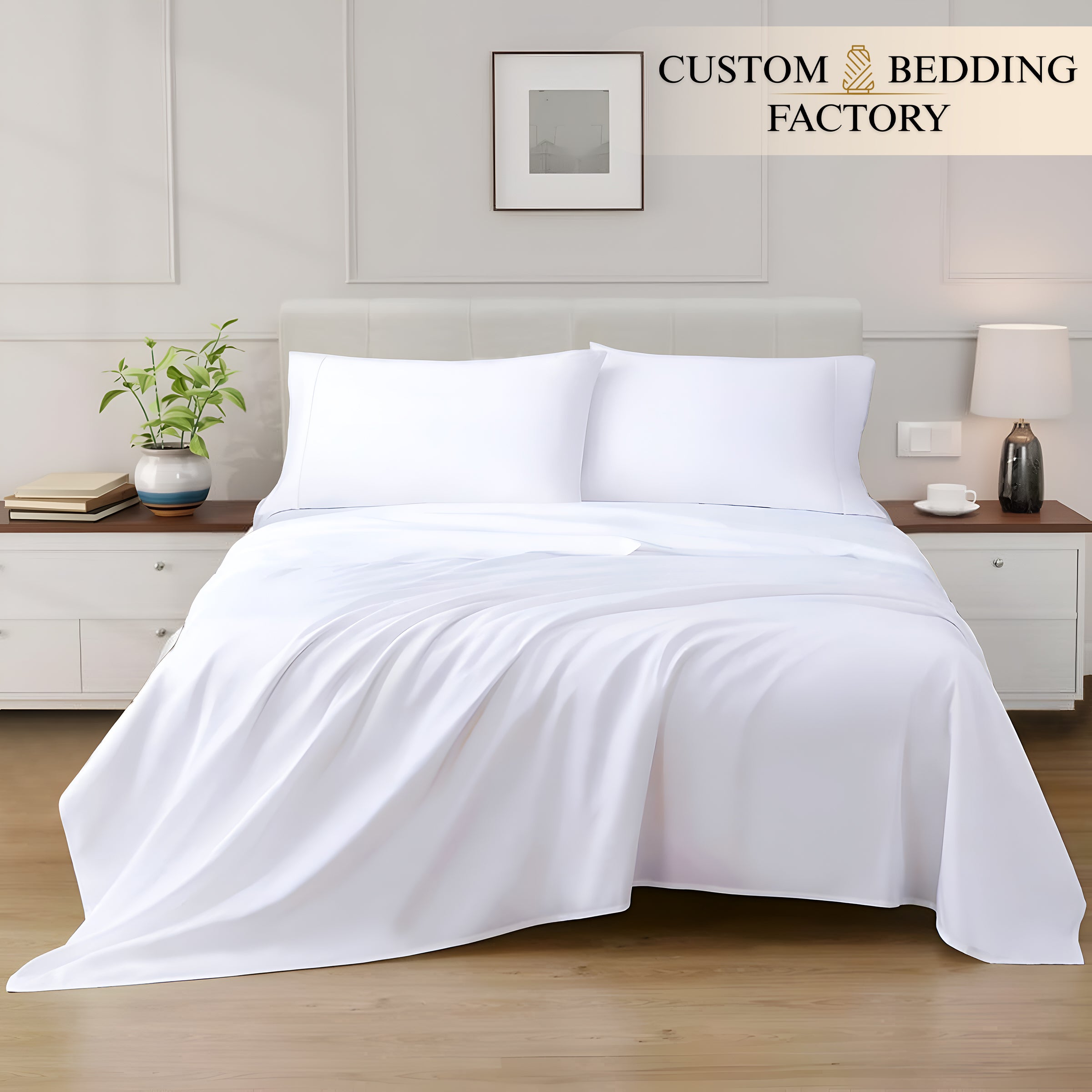 White bedding set on a bed in a bedroom with 'Custom Bedding Factory' branding.