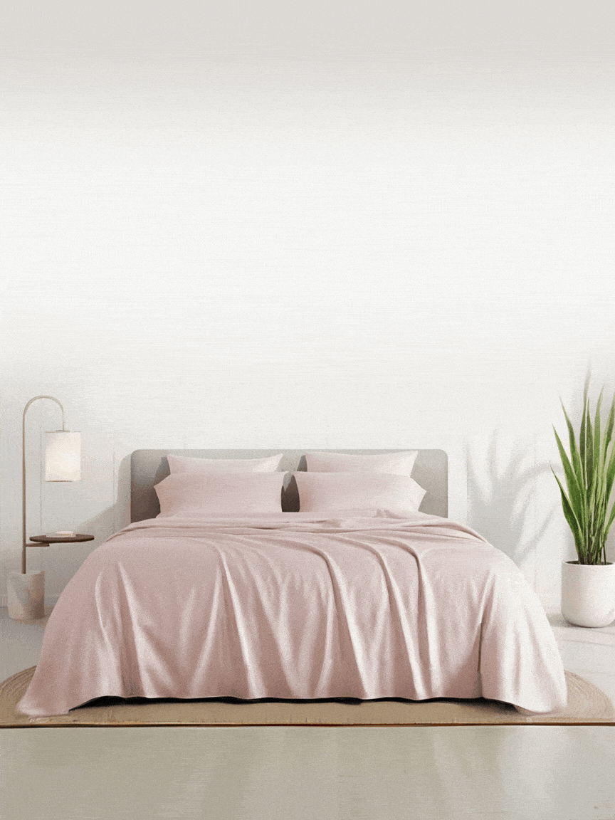 luxury bed with peach colored bed sheet