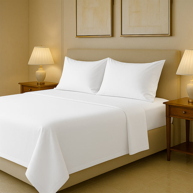 Luxury 400 thread count Egyptian cotton bed sheets neatly spread on queen size bed